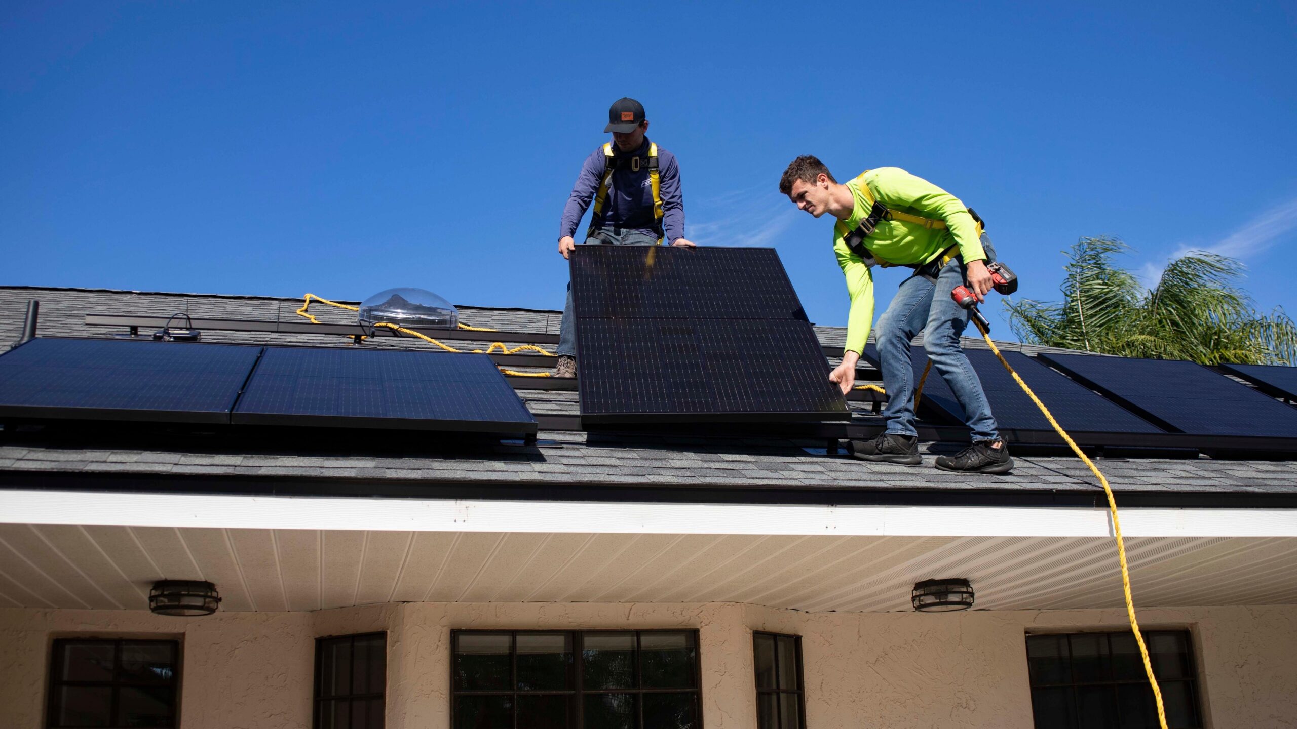 People installing solar panels on a roof